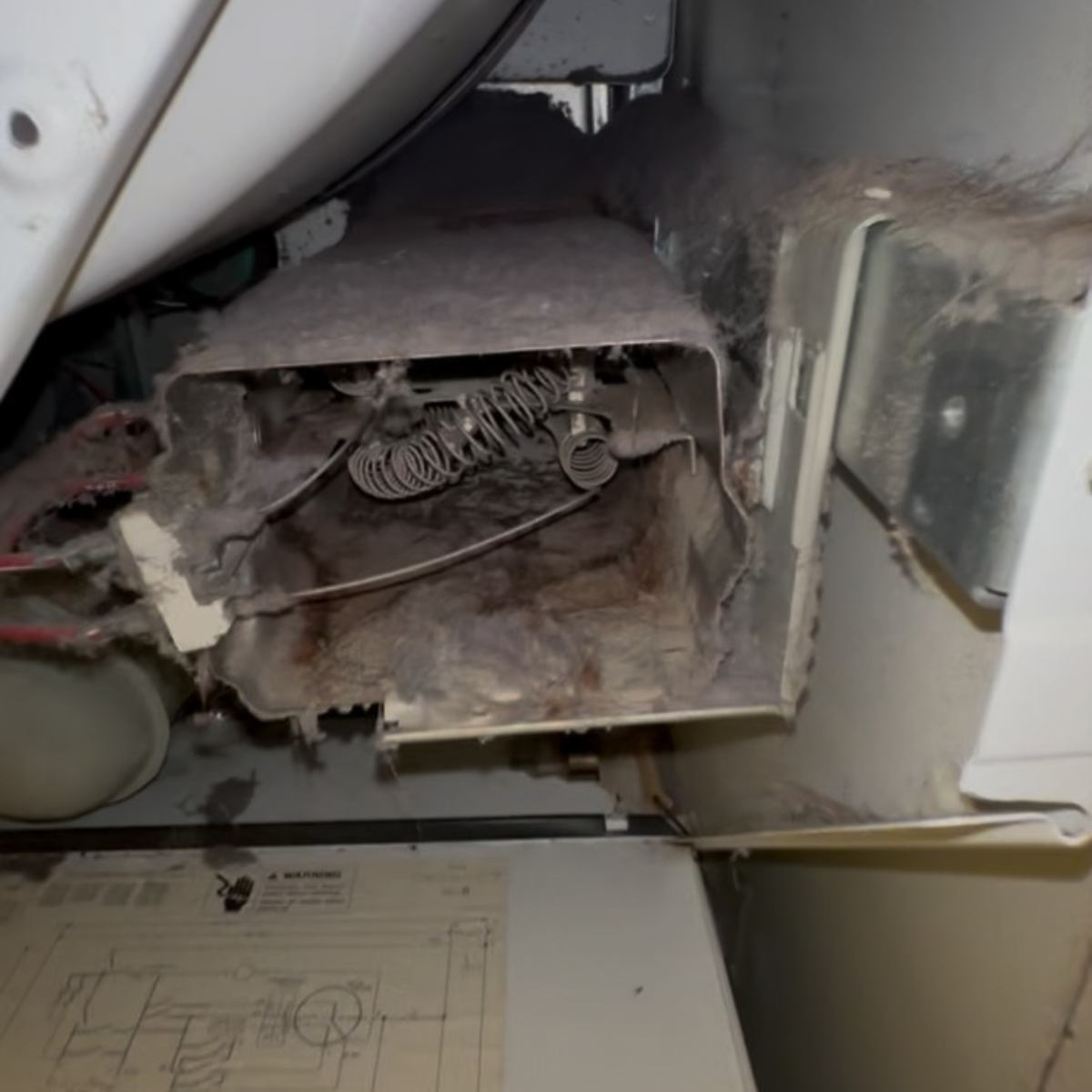 Accumulated lint and debris inside a dryer vent, illustrating the importance of professional duct and dryer cleaning services for fire prevention and improved air quality.