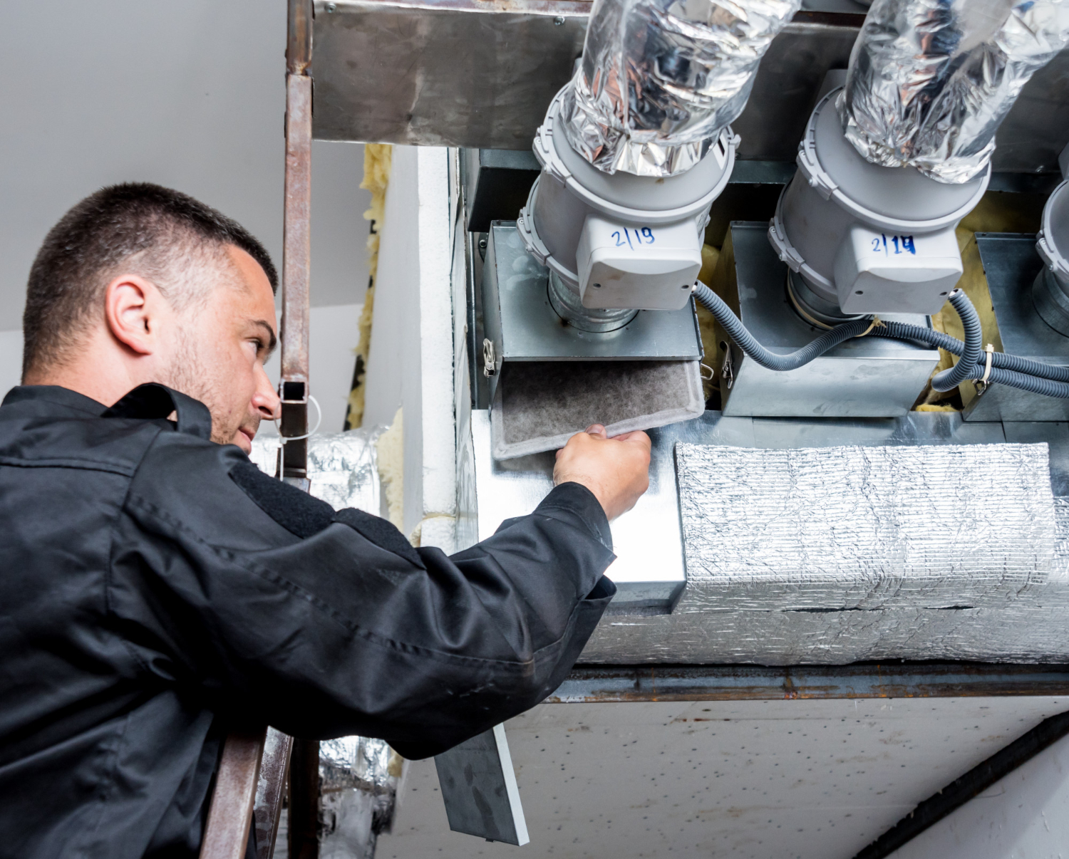 Technician cleaning dryer vent duct, ensuring thorough maintenance for improved air quality and fire safety.