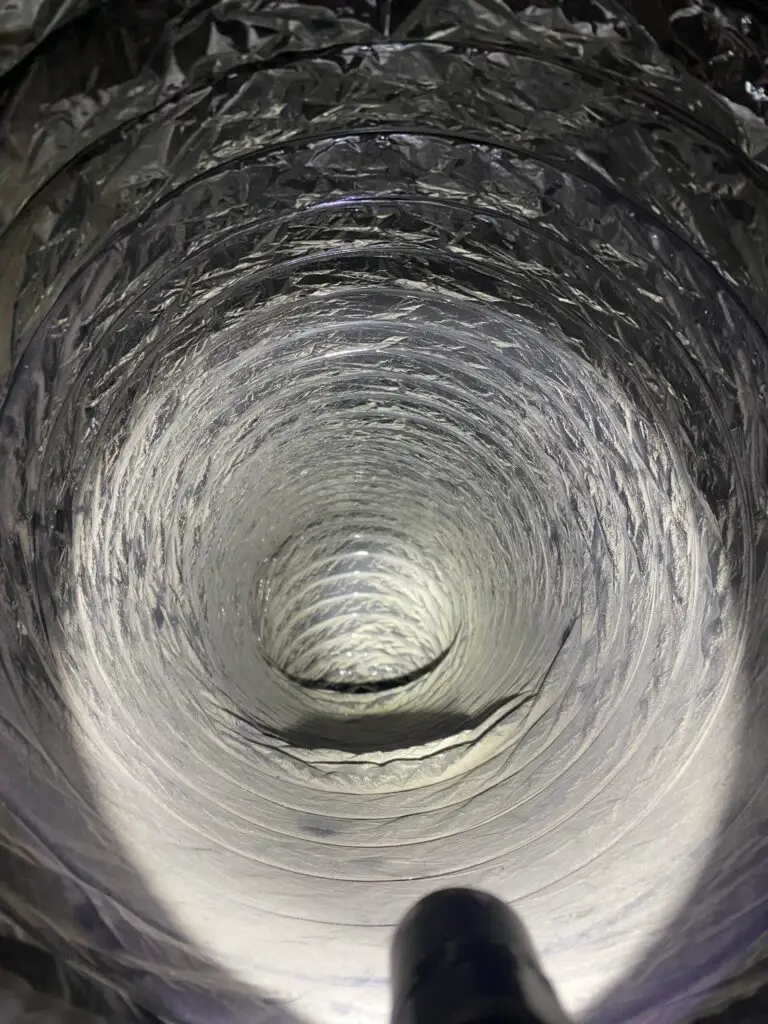 Interior view of a clean air duct showing smooth, shiny surfaces, illustrating the importance of air duct cleaning for improved indoor air quality and HVAC efficiency.