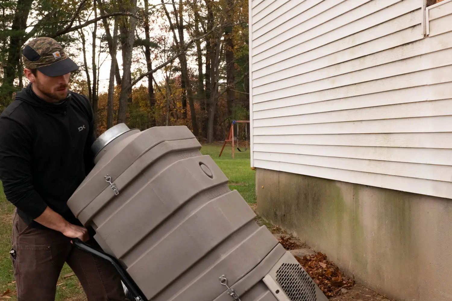 Technician inspecting dryer vent hood and ductwork in Salisbury, MA coastal home.