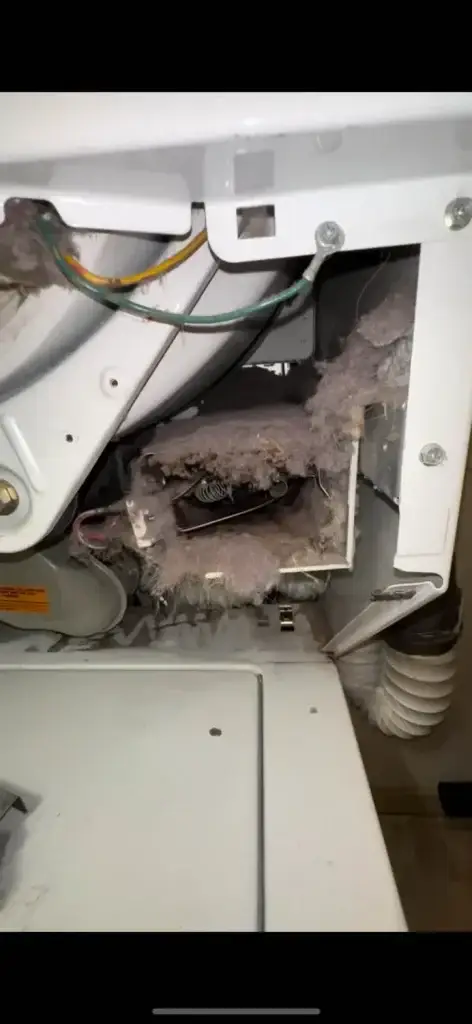 Lint buildup inside a dryer vent, showcasing accumulated debris and potential fire hazards, relevant to air duct and dryer vent cleaning services.